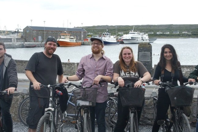 a group of people riding on the back of a bicycle