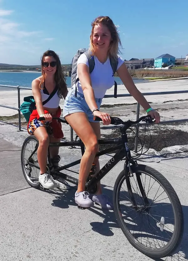 download (10) a woman riding on the back of a bicycle