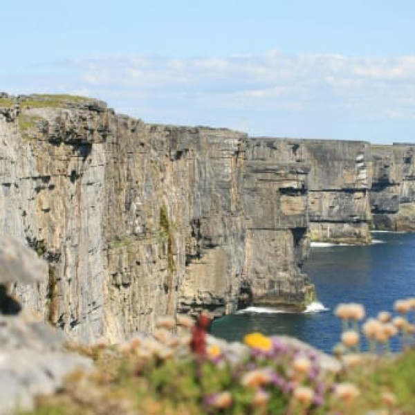 a stone castle next to a body of water