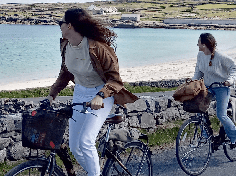 a woman riding on the back of a bicycle