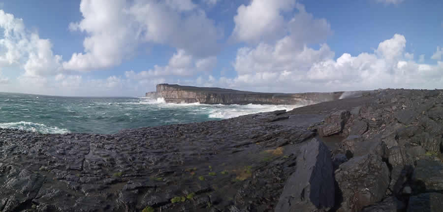 a rocky beach next to a body of water