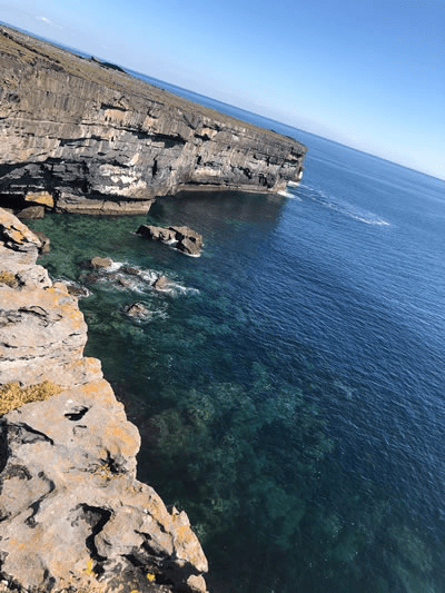 a rocky island in the middle of a body of water