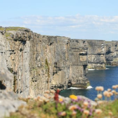 a stone castle next to a body of water