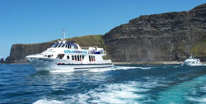 a small boat in a body of water with a mountain in the background