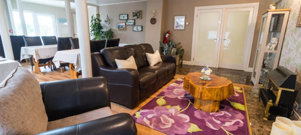 a living room filled with furniture and a large window